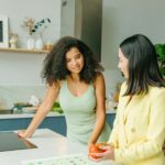 Dietary consultation in a home kitchen with nutritionist and client discussing healthy eating.